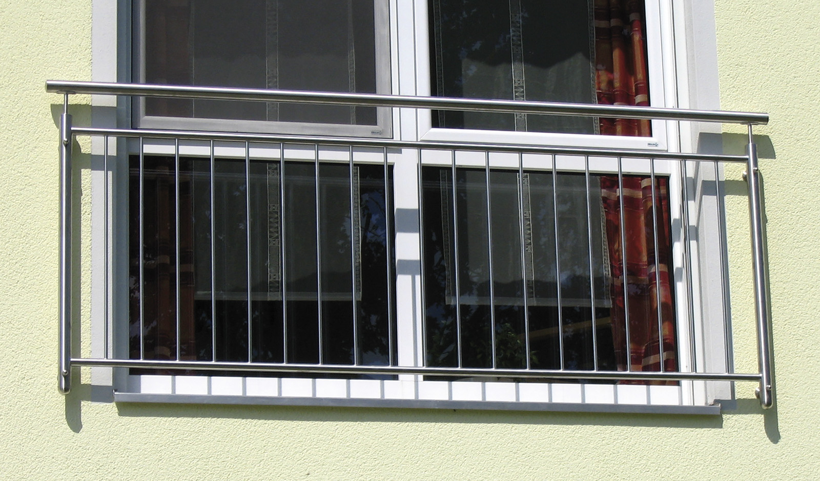 Französischer Balkon aus Edelstahl vor einem Fenster